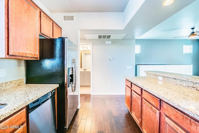 kitchen with dark wood-style floors, brown cabinets, stainless steel appliances, visible vents, and ceiling fan