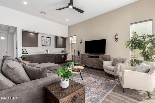 living room with ceiling fan and light wood-type flooring