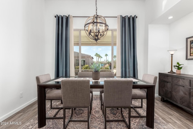 dining room with a notable chandelier and wood-type flooring