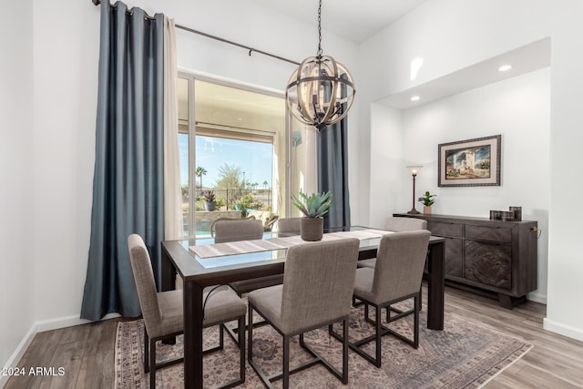 dining room featuring hardwood / wood-style flooring and a notable chandelier