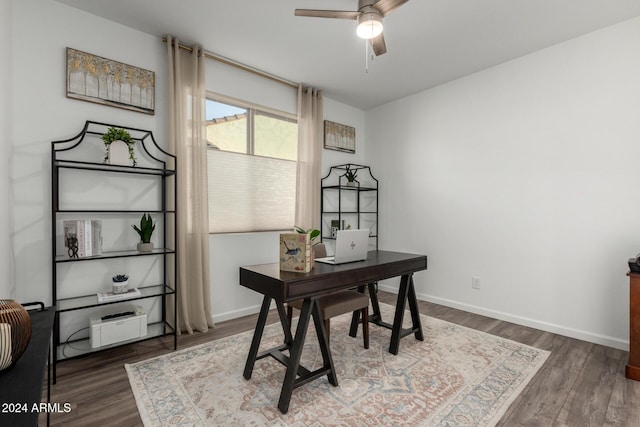 office space featuring ceiling fan and dark hardwood / wood-style floors