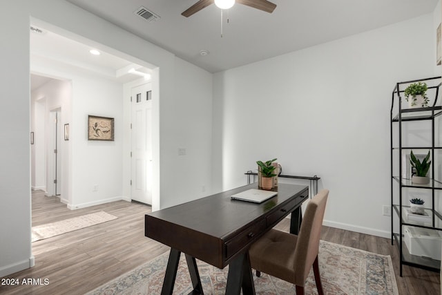 office with ceiling fan and light hardwood / wood-style floors