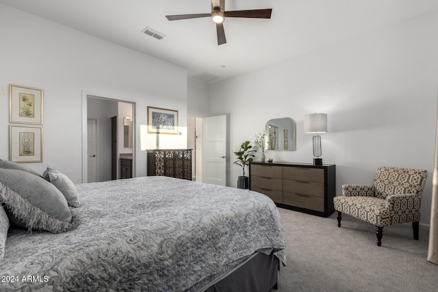 bedroom featuring connected bathroom, light colored carpet, and ceiling fan