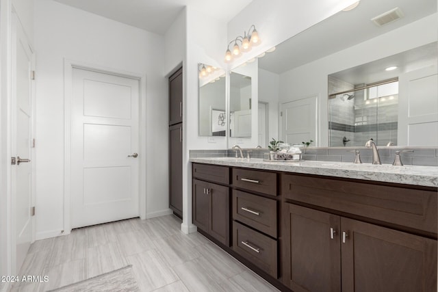 bathroom featuring vanity and a shower with shower door