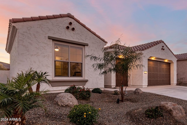 mediterranean / spanish-style house with a garage