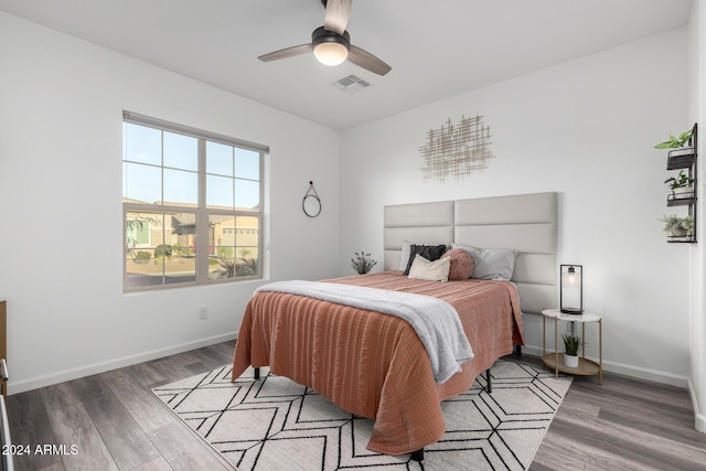 bedroom with ceiling fan and hardwood / wood-style flooring