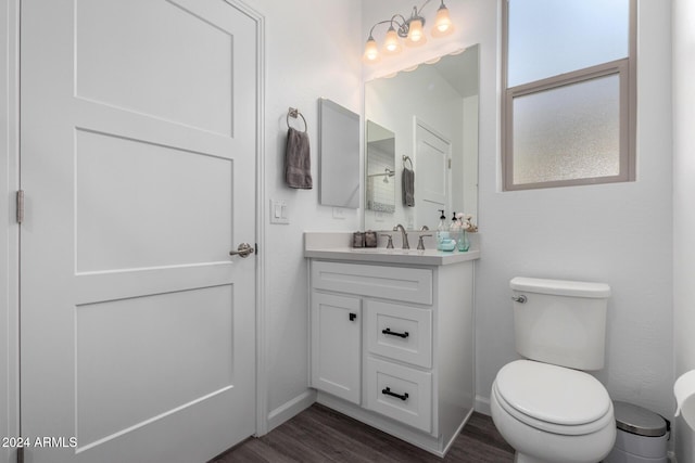 bathroom featuring vanity, hardwood / wood-style flooring, and toilet