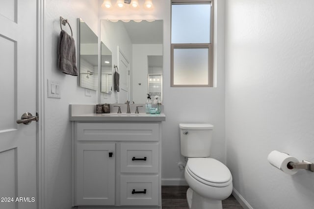 bathroom featuring hardwood / wood-style flooring, vanity, and toilet