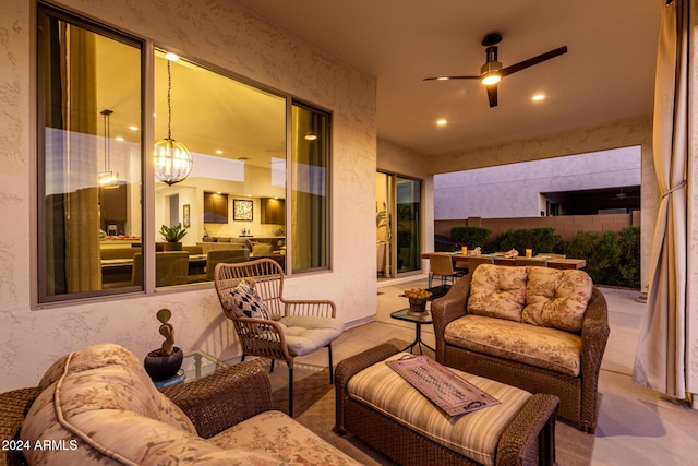 view of patio with an outdoor living space and ceiling fan