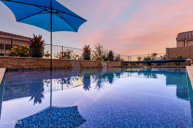 view of pool at dusk