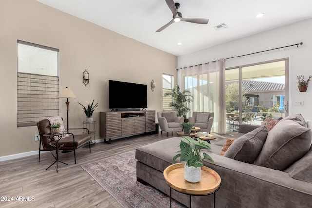 living room with wood-type flooring and ceiling fan