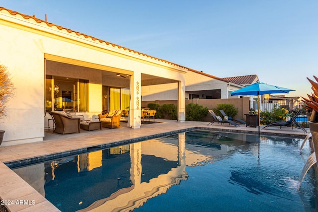 view of pool with outdoor lounge area and a patio