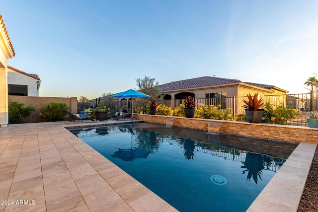 view of swimming pool with a patio and pool water feature