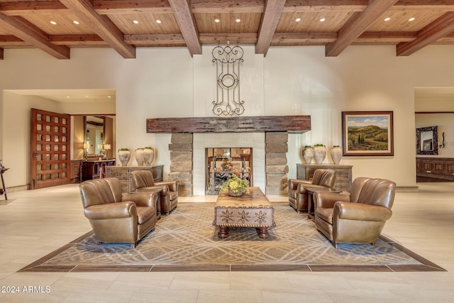 living room featuring beam ceiling, a stone fireplace, and wooden ceiling