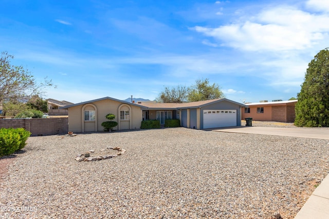 2232 Carmelita Dr, Sierra Vista, AZ 85635 - ranch-style house with concrete driveway, fence, and an attached garage