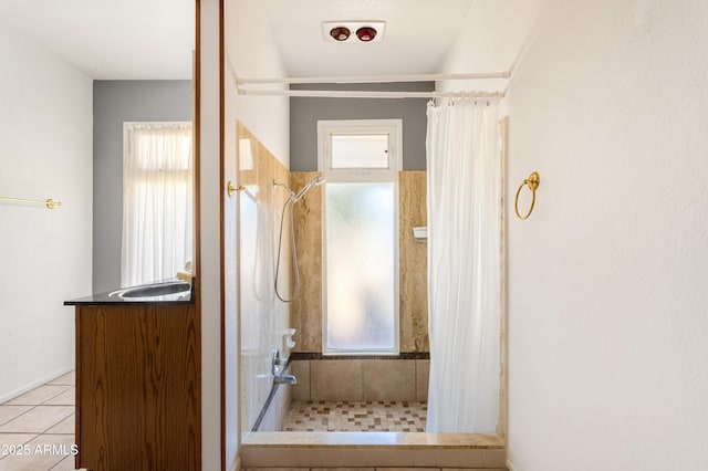 2232 Carmelita Dr, Sierra Vista, AZ 85635 - bathroom featuring tiled shower, vanity, and tile patterned flooring