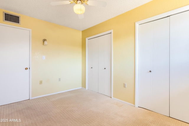 2232 Carmelita Dr, Sierra Vista, AZ 85635 - unfurnished bedroom featuring visible vents, baseboards, carpet flooring, and two closets