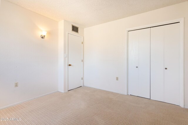 2232 Carmelita Dr, Sierra Vista, AZ 85635 - unfurnished bedroom with carpet flooring, visible vents, a closet, and a textured ceiling
