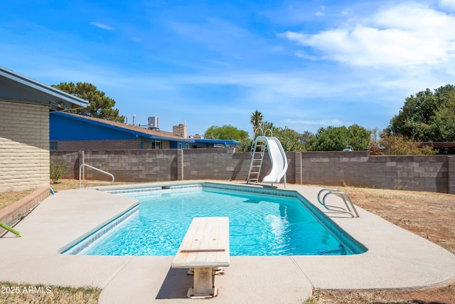 2232 Carmelita Dr, Sierra Vista, AZ 85635 - view of swimming pool featuring a diving board, a water slide, a fenced backyard, a patio, and a fenced in pool