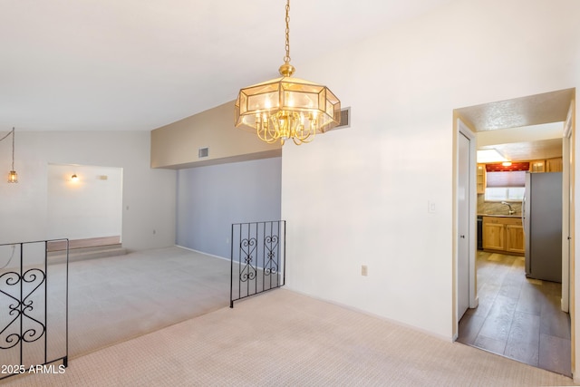 2232 Carmelita Dr, Sierra Vista, AZ 85635 - empty room featuring light carpet, visible vents, a sink, and an inviting chandelier