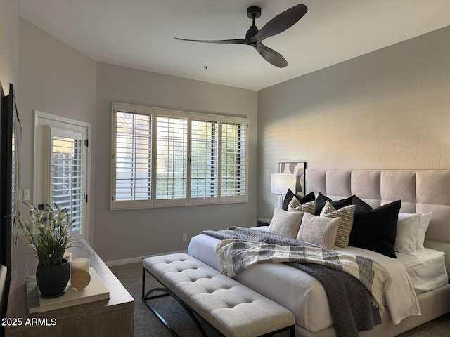 carpeted bedroom with baseboards and a ceiling fan