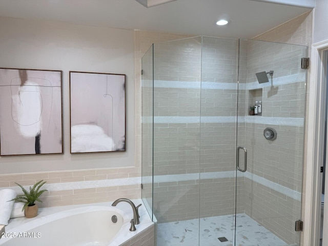 full bath featuring a bath, recessed lighting, and a stall shower