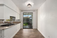 kitchen featuring white cabinets, black gas stovetop, and wood finished floors