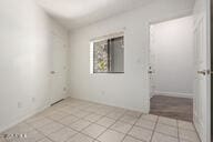 spare room featuring light tile patterned flooring