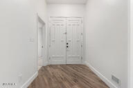 interior space with baseboards and wood finished floors