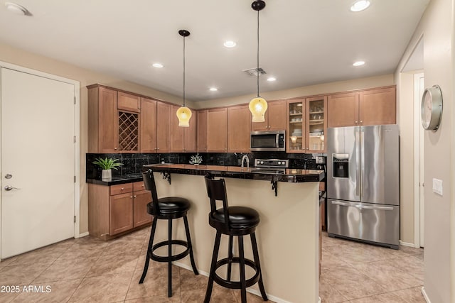 5840 E Holmes Ave, Mesa, AZ 85206 - kitchen with appliances with stainless steel finishes, decorative backsplash, glass insert cabinets, tile counters, and recessed lighting