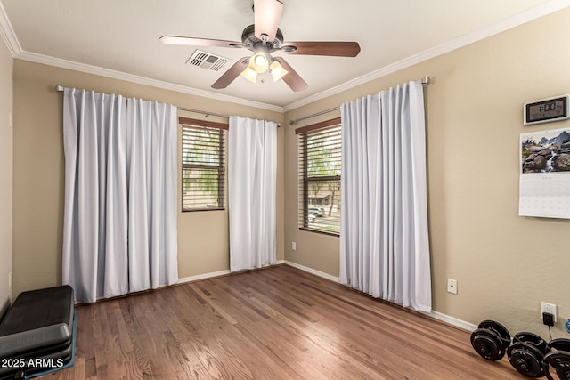 5840 E Holmes Ave, Mesa, AZ 85206 - empty room with wood finished floors, crown molding, ceiling fan, and baseboards