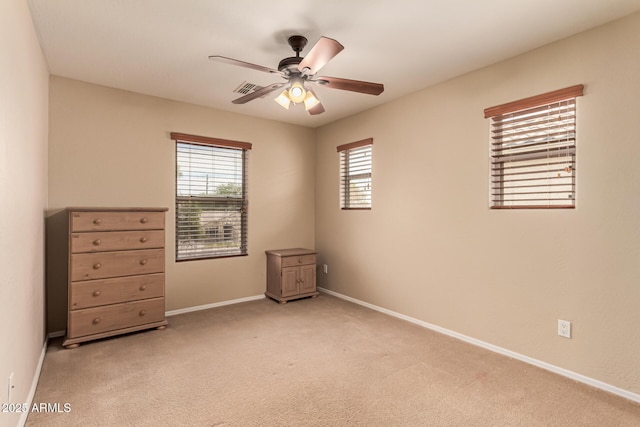 5840 E Holmes Ave, Mesa, AZ 85206 - empty room featuring light carpet, a ceiling fan, and baseboards