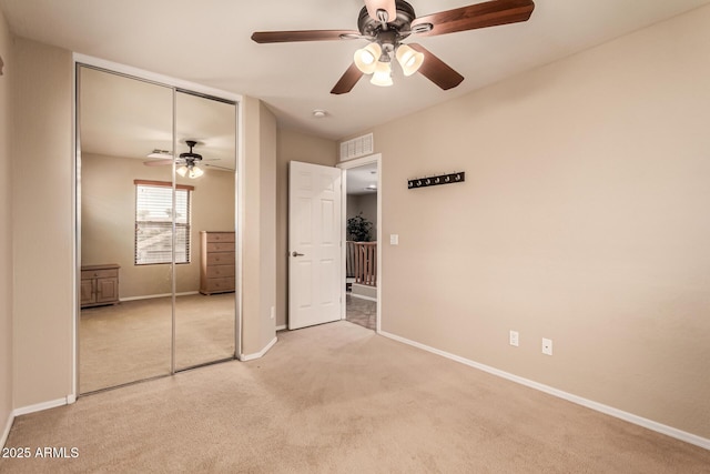 5840 E Holmes Ave, Mesa, AZ 85206 - unfurnished bedroom with a closet, light carpet, baseboards, and ceiling fan