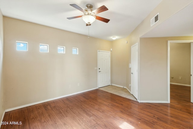 empty room with ceiling fan and light wood-type flooring