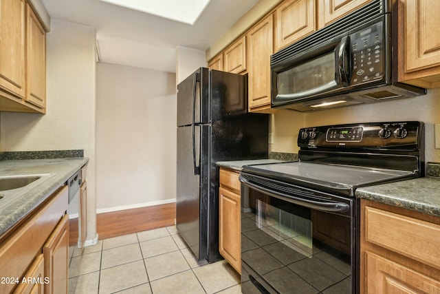 kitchen featuring light tile patterned floors and black appliances