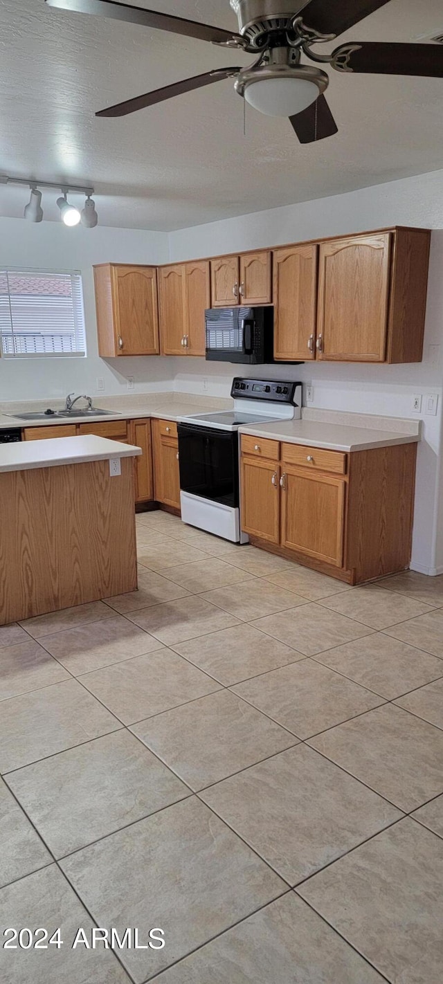 16021 N 30th St Unit 113, Phoenix, AZ 85032 - kitchen featuring range with electric stovetop, black microwave, light countertops, and a ceiling fan