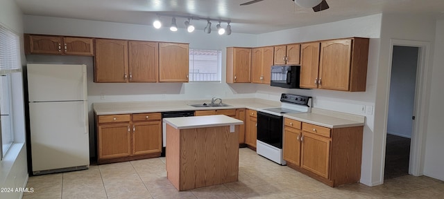 16021 N 30th St Unit 113, Phoenix, AZ 85032 - kitchen featuring freestanding refrigerator, electric stove, black microwave, dishwashing machine, and a center island