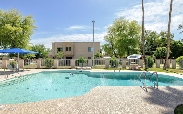community pool featuring a patio and fence