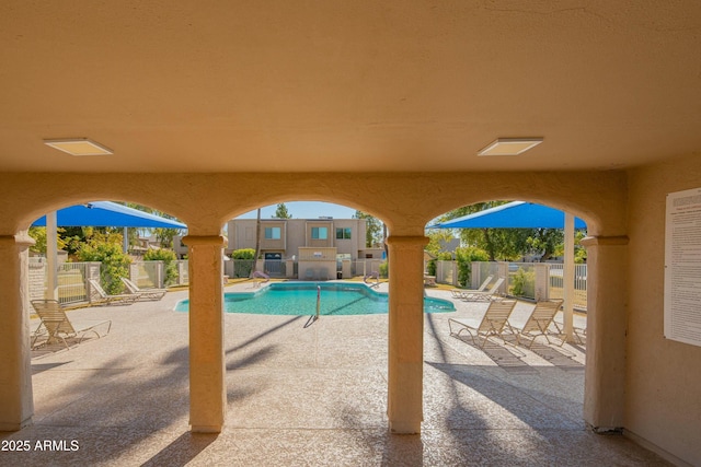 pool featuring a patio and fence