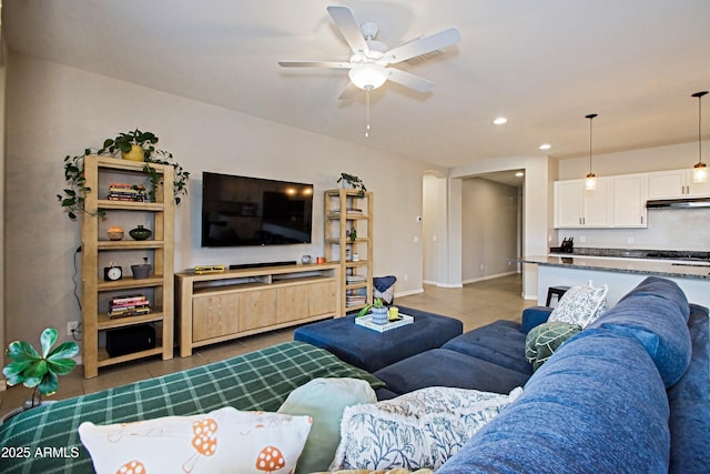 living room with light tile patterned floors, ceiling fan, baseboards, and recessed lighting