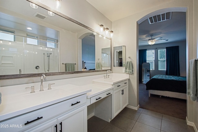 bathroom with tile patterned flooring, visible vents, a sink, and ensuite bath