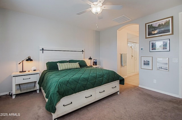 bedroom featuring arched walkways, visible vents, light carpet, and baseboards