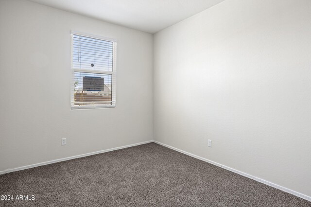 1343 W Hess Ave, Coolidge, AZ 85128 - unfurnished room featuring baseboards and dark carpet