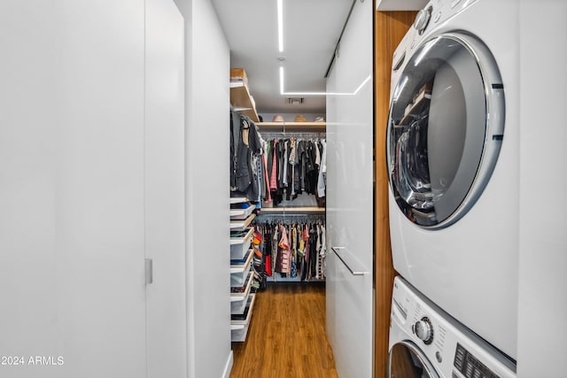 washroom featuring stacked washer and clothes dryer and hardwood / wood-style floors