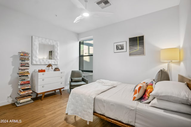 bedroom with ceiling fan and hardwood / wood-style floors