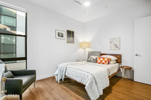 bedroom with hardwood / wood-style floors