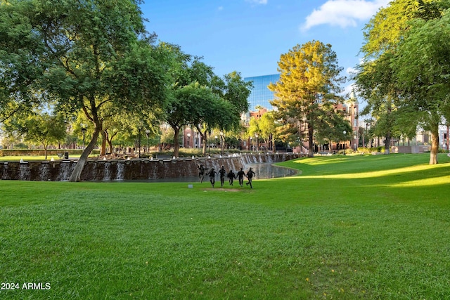 view of home's community featuring a water view and a yard