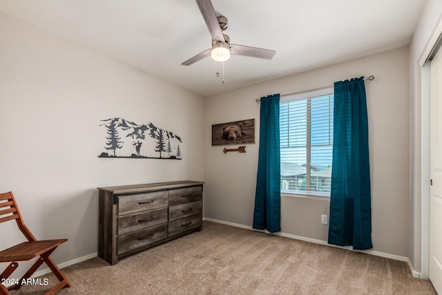 interior space with light carpet and ceiling fan