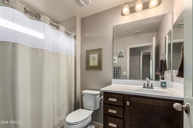 bathroom featuring toilet and vanity