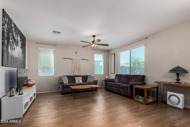 living room featuring ceiling fan and hardwood / wood-style floors